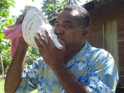 A shell is blown to start the traditional ceremony