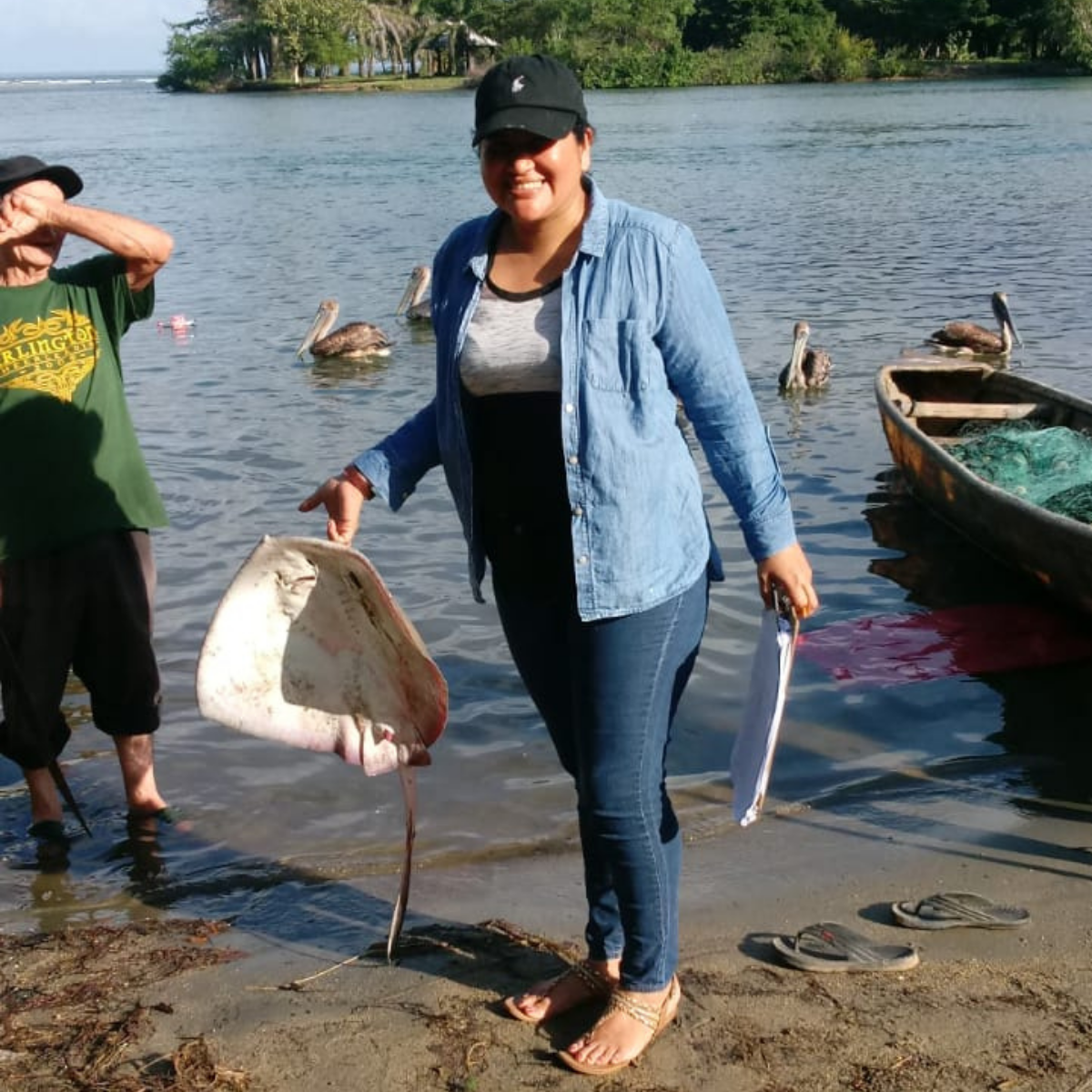Ana Valdez helps carry the catch from the boat to be measured
