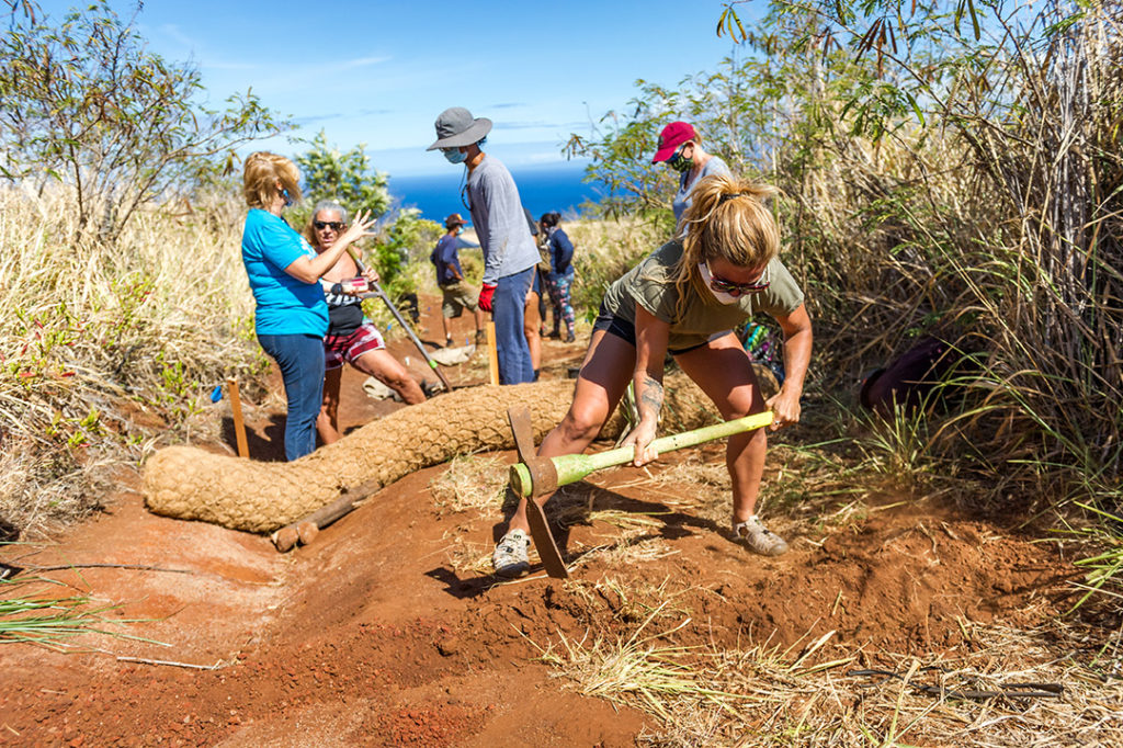 volunteers help restore an old dirt road in Maui, Hawaii