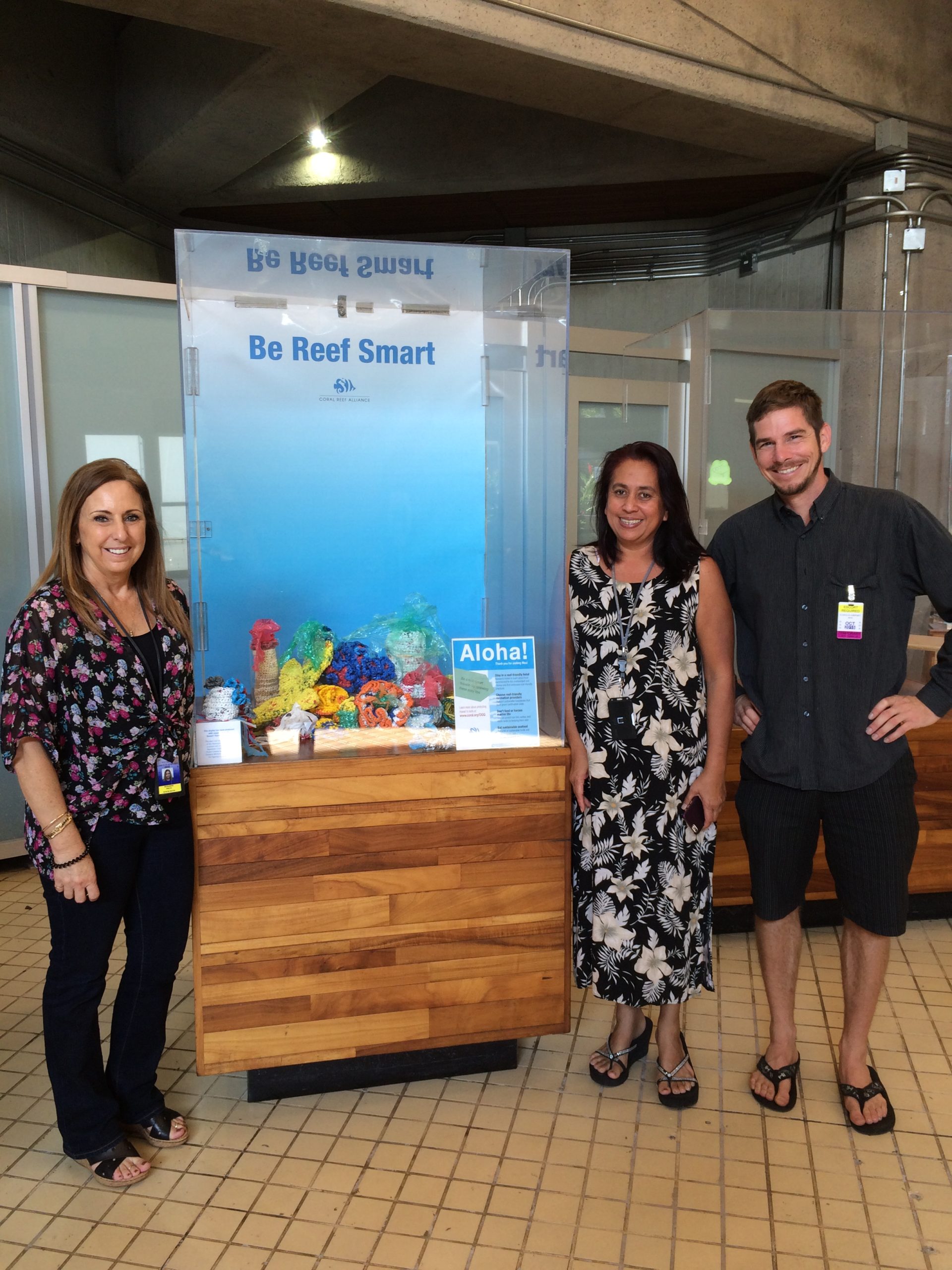 Hawai'i Field Manager Wes Crile with Maui Airport Representatives in front of CORAL's displays